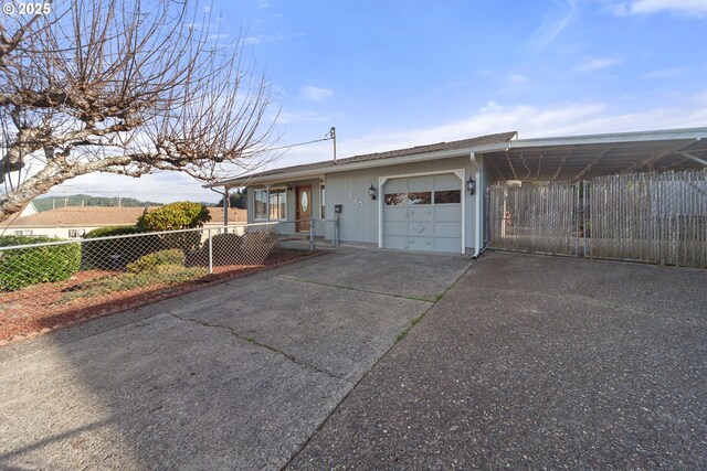 view of front facade with a garage and a carport