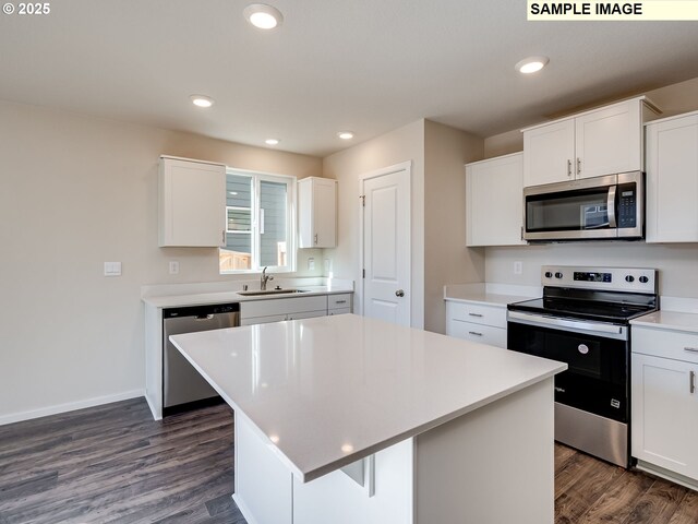 2133 NE 4th Ave, Battle Ground, WA 98604 - kitchen featuring appliances with stainless steel finishes, a sink, dark wood-style floors, white cabinets, and recessed lighting