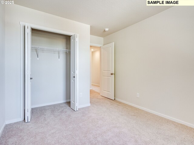 2133 NE 4th Ave, Battle Ground, WA 98604 - unfurnished bedroom with carpet floors, baseboards, and a closet
