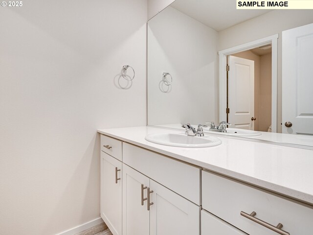 2133 NE 4th Ave, Battle Ground, WA 98604 - bathroom featuring vanity, baseboards, and toilet