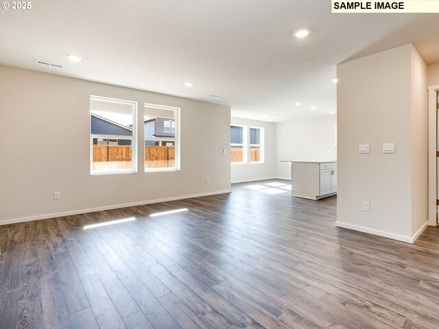 2133 NE 4th Ave, Battle Ground, WA 98604 - unfurnished living room with dark wood-type flooring, baseboards, and recessed lighting