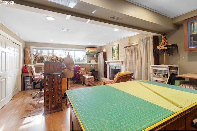 interior space with a fireplace and light hardwood / wood-style floors