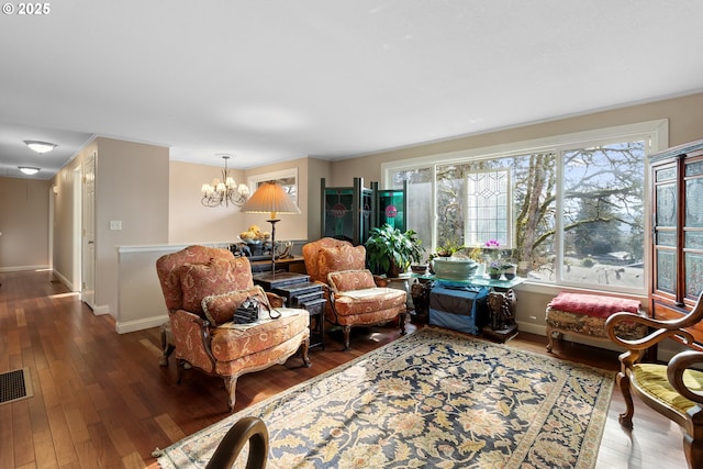 living room with dark hardwood / wood-style flooring and a chandelier