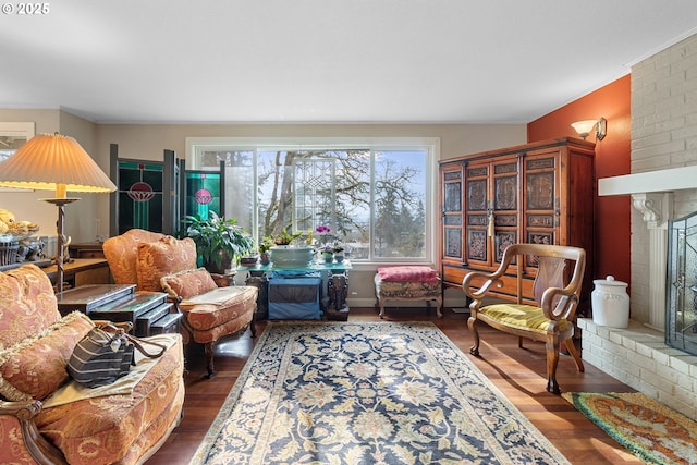 living room featuring dark hardwood / wood-style flooring and a brick fireplace