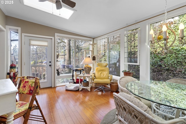 sunroom with ceiling fan and lofted ceiling