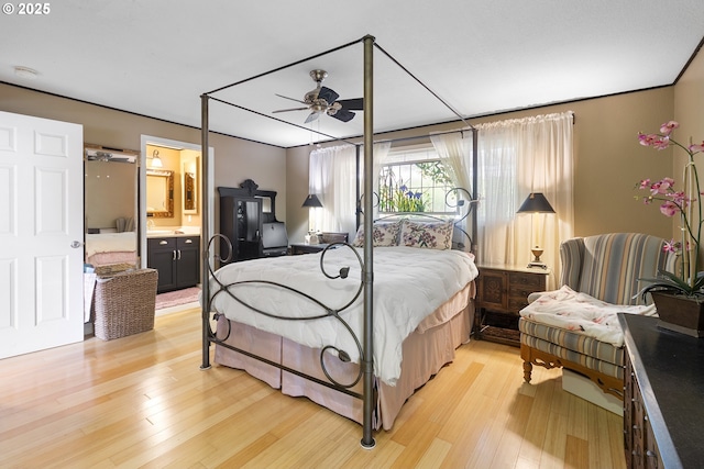 bedroom with ensuite bathroom and light hardwood / wood-style floors