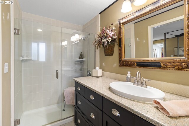 bathroom featuring vanity and a shower with door