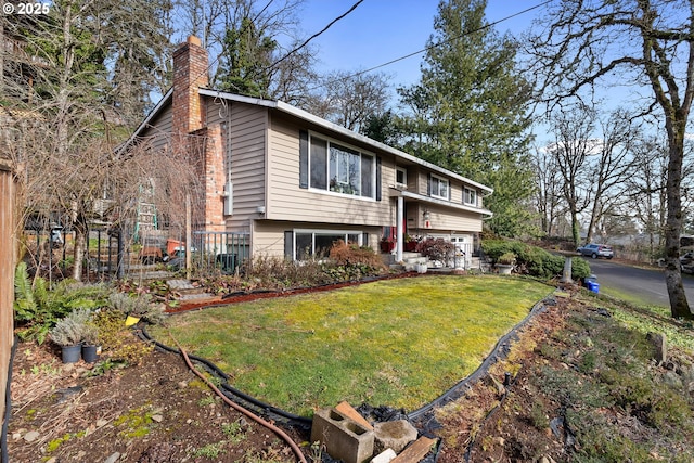 raised ranch featuring a front yard and central air condition unit