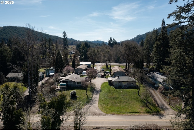 bird's eye view with a wooded view