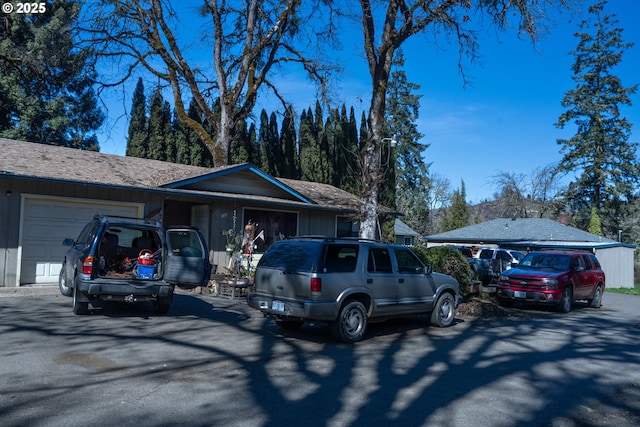 ranch-style home featuring an attached garage and driveway