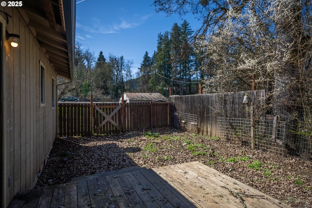 view of yard with a deck and a fenced backyard