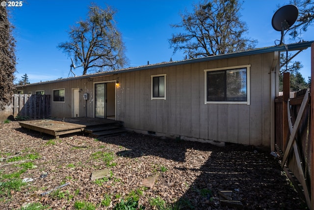 view of front of home featuring a wooden deck and fence