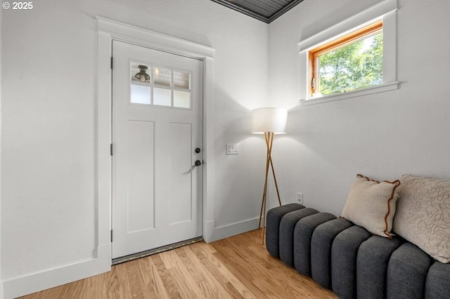 entryway with light wood finished floors and baseboards