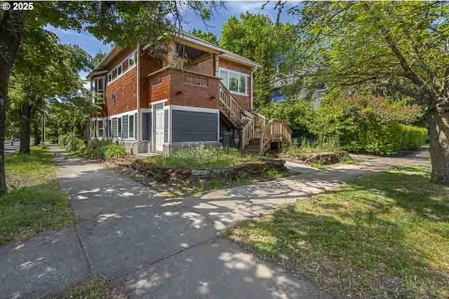 view of front of home featuring stairway