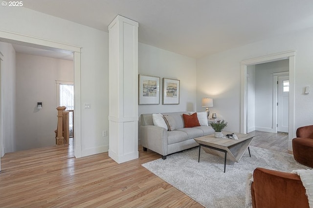 living room with light wood-type flooring and baseboards