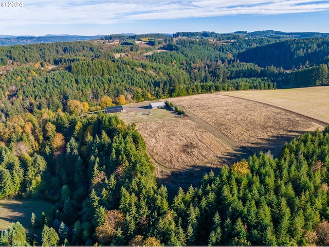 aerial view featuring a forest view and a mountain view