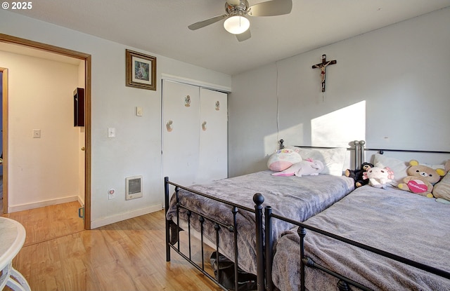 bedroom with a closet, ceiling fan, and light hardwood / wood-style floors