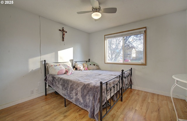 bedroom featuring ceiling fan and light hardwood / wood-style floors