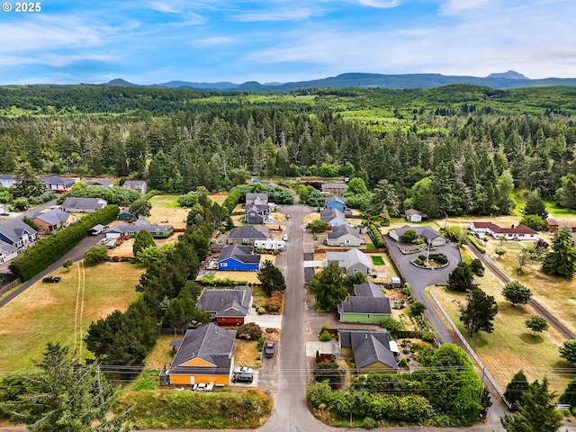 1305 Sandy Ridge Rd, Gearhart, OR 97138 - aerial perspective of suburban area featuring a forest and a mountain backdrop