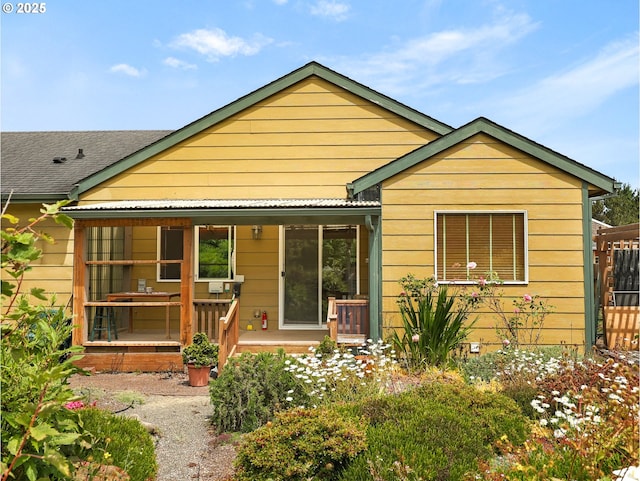 1305 Sandy Ridge Rd, Gearhart, OR 97138 - back of house featuring a porch and roof with shingles