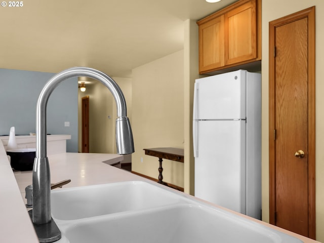 1305 Sandy Ridge Rd, Gearhart, OR 97138 - kitchen view of freestanding refrigerator, light countertops, and brown cabinets