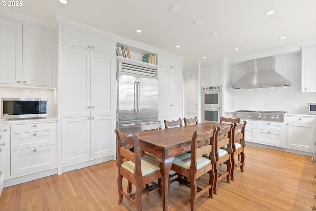 dining space with light wood-style flooring and recessed lighting