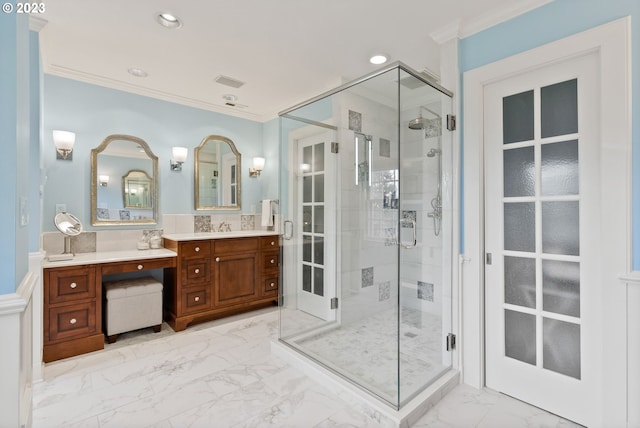 full bathroom featuring marble finish floor, ornamental molding, a shower stall, and vanity