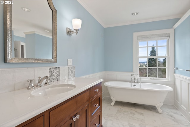 bathroom with a wainscoted wall, marble finish floor, ornamental molding, and a soaking tub