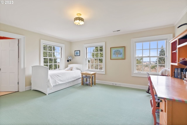 carpeted bedroom featuring ornamental molding, visible vents, and baseboards