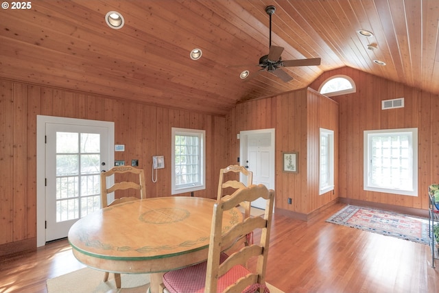 dining area featuring a wealth of natural light, lofted ceiling, wood ceiling, and light wood-style floors