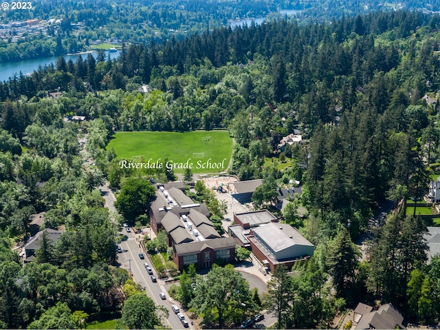 drone / aerial view with a water view, a residential view, and a view of trees