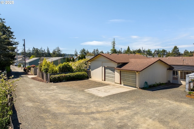 1088 Nopal St, Florence, OR 97439 - ranch-style house with a detached garage, a shingled roof, and fence