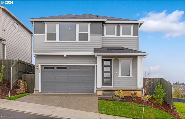 prairie-style home with a garage and a front yard