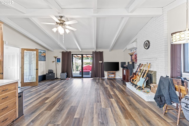 living room featuring lofted ceiling with beams, a wall mounted AC, and dark wood-style floors