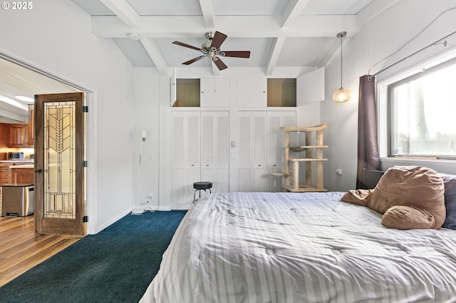 bedroom with beam ceiling, baseboards, and dark wood-style flooring