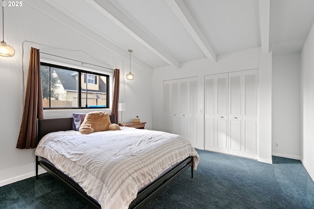 carpeted bedroom with vaulted ceiling with beams, baseboards, and multiple closets