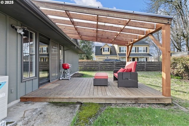 wooden deck featuring a fenced backyard, a lawn, and a pergola