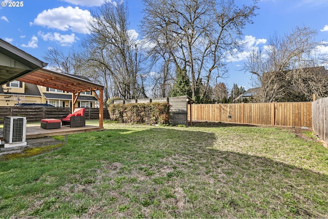 view of yard with a fenced backyard, a deck, and a pergola