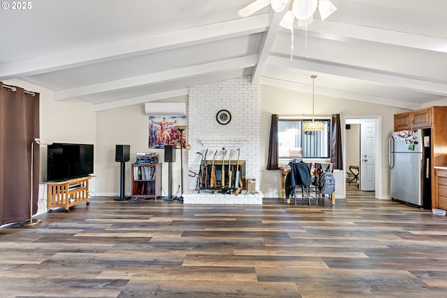 living area featuring vaulted ceiling with beams, a wall mounted AC, a fireplace, and wood finished floors