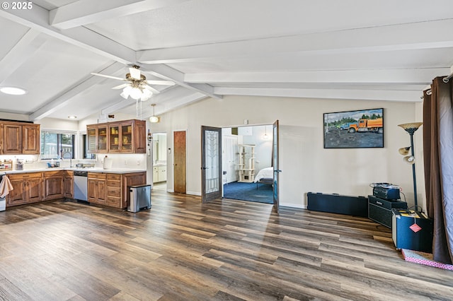 kitchen with dark wood-type flooring, light countertops, brown cabinets, and dishwasher