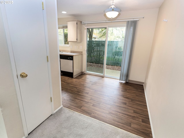 interior space with baseboards and wood finished floors