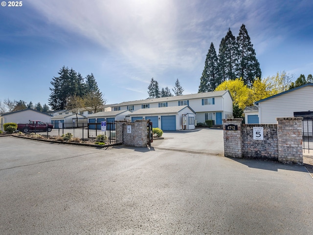 townhome / multi-family property featuring a gate and a fenced front yard