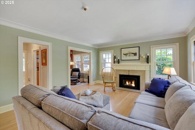 3034 NE Tillamook St, Portland, OR 97212 - living area featuring crown molding, light wood-style flooring, and a tile fireplace
