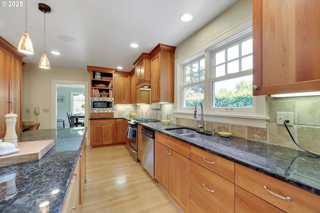 3034 NE Tillamook St, Portland, OR 97212 - kitchen featuring stainless steel appliances, open shelves, light wood-style flooring, brown cabinetry, and recessed lighting