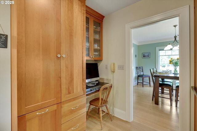 3034 NE Tillamook St, Portland, OR 97212 - home office featuring built in desk, light wood-style floors, and crown molding