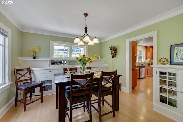3034 NE Tillamook St, Portland, OR 97212 - dining room with crown molding, light wood finished floors, and a chandelier
