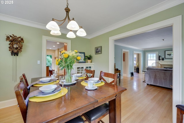 3034 NE Tillamook St, Portland, OR 97212 - dining space featuring light wood finished floors, ornamental molding, and a chandelier