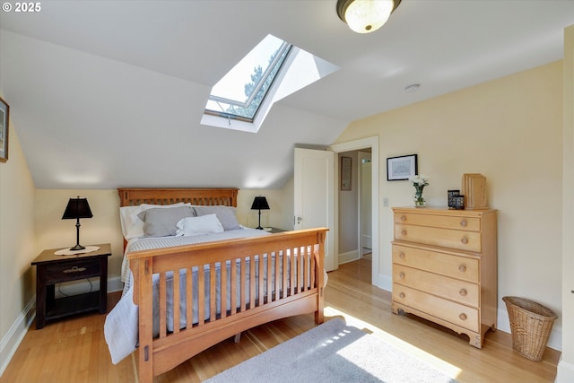 3034 NE Tillamook St, Portland, OR 97212 - bedroom with a skylight, vaulted ceiling, and light wood-style flooring