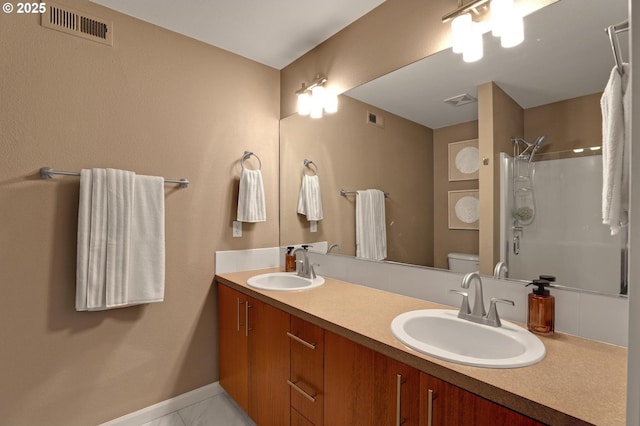 full bathroom featuring toilet, visible vents, and a sink