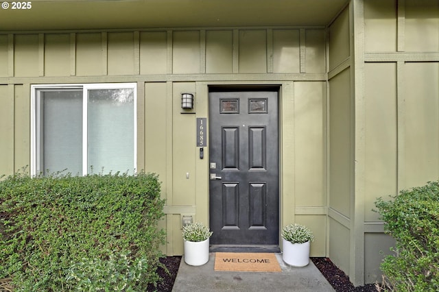 view of exterior entry featuring board and batten siding